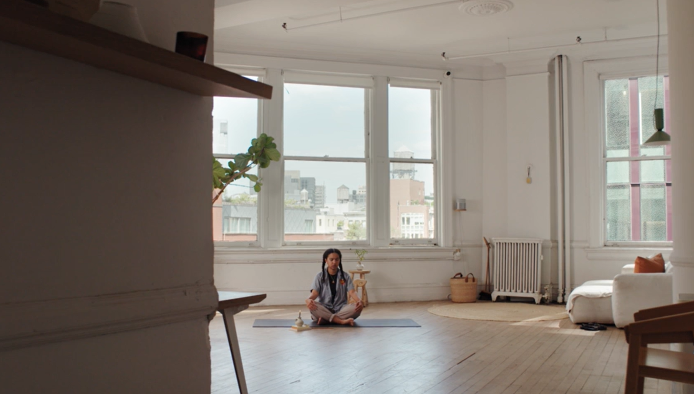 Tai, a mixed-race nonbinary person, does a peaceful yoga pose